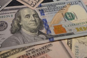 hundred-dollar-bill-stacks Hundred-dollar bills stacked atop one another